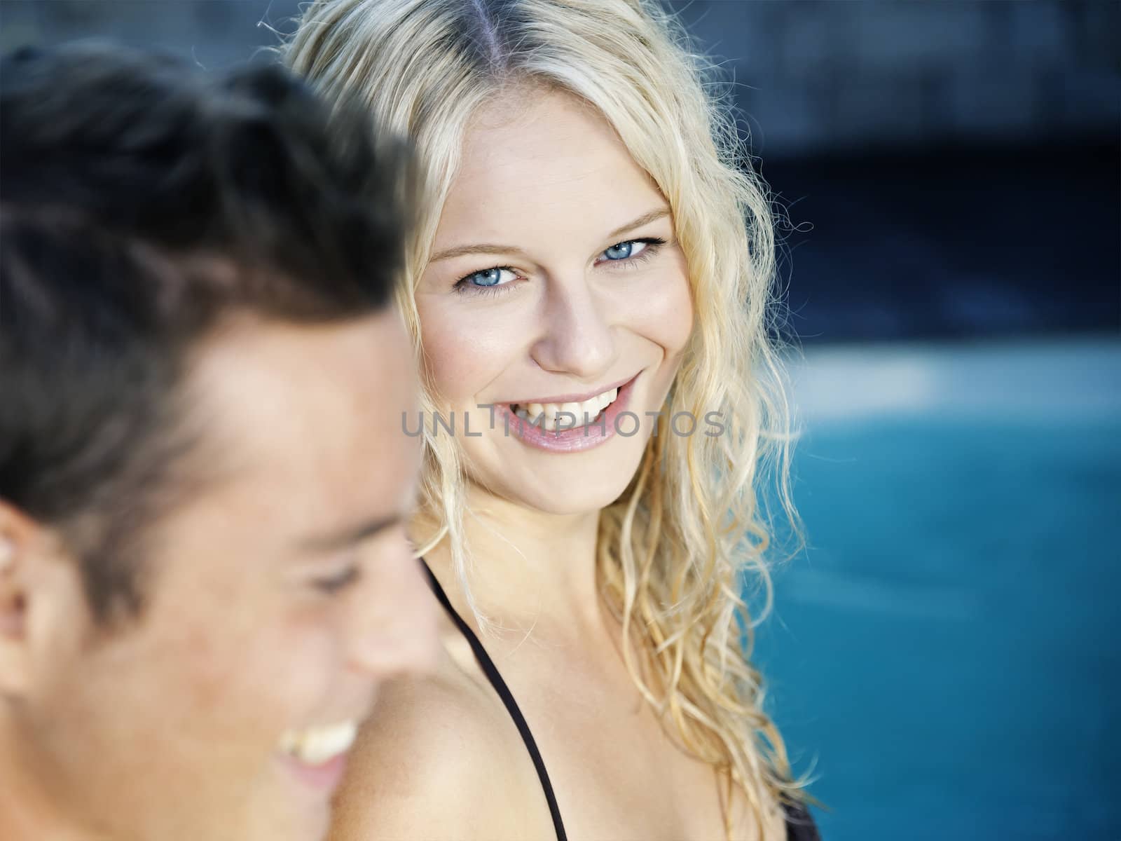 A beautiful blonde woman in the blue pool