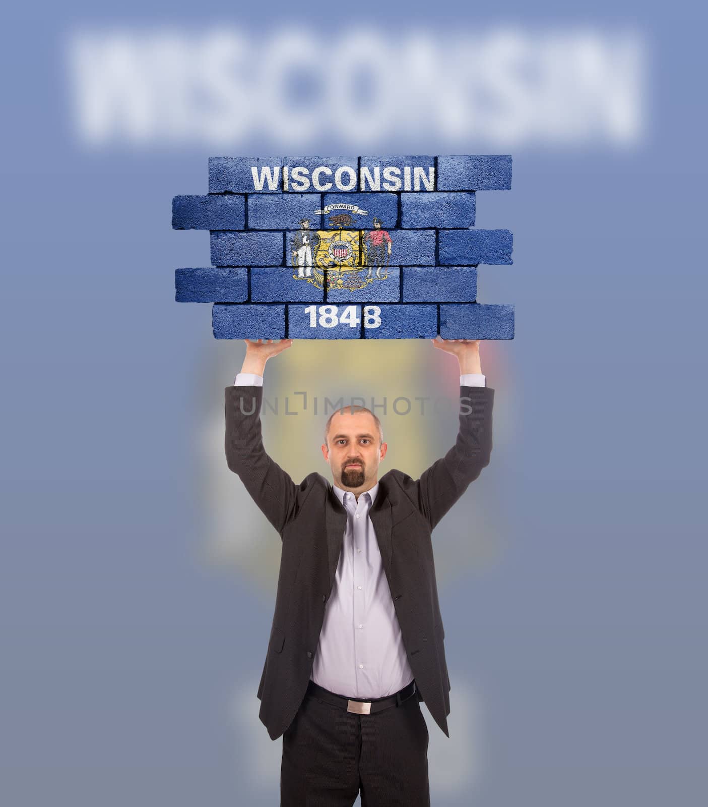 Businessman holding a large piece of a brick wall, flag of Wisconsin, isolated on national flag