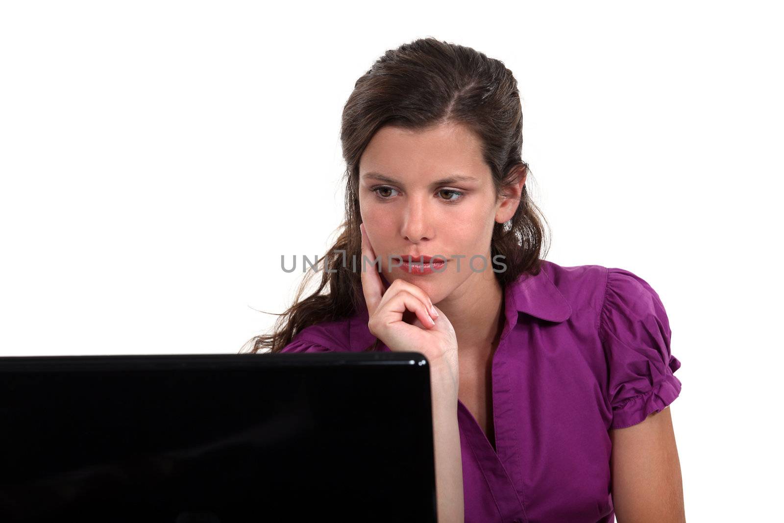 Brunette thinking at desk