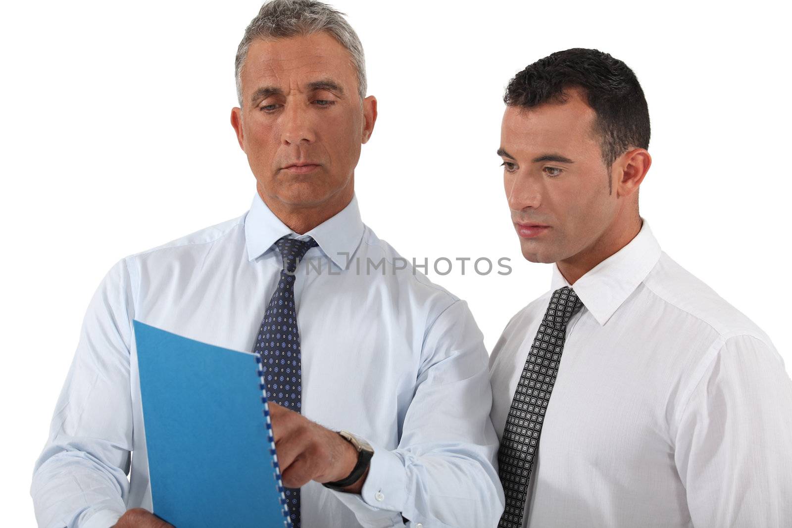 businessman showing a report to a colleague by phovoir
