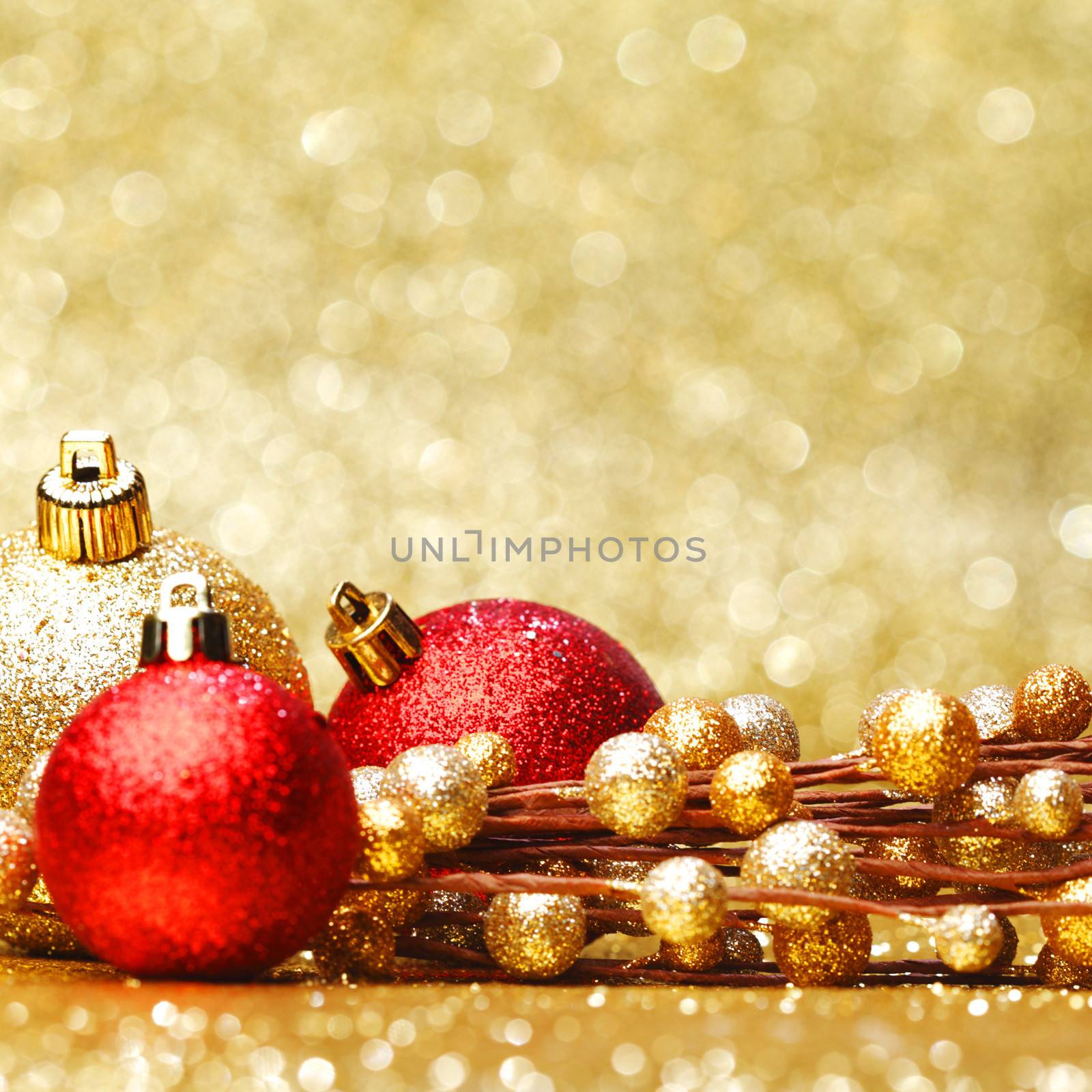 Colorful christmas decoration on shiny golden background