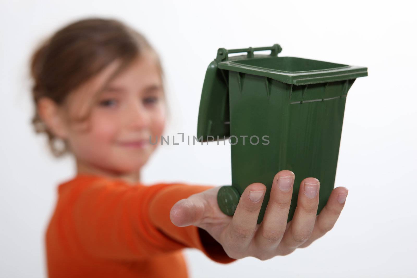 Girl holding recycling bin by phovoir