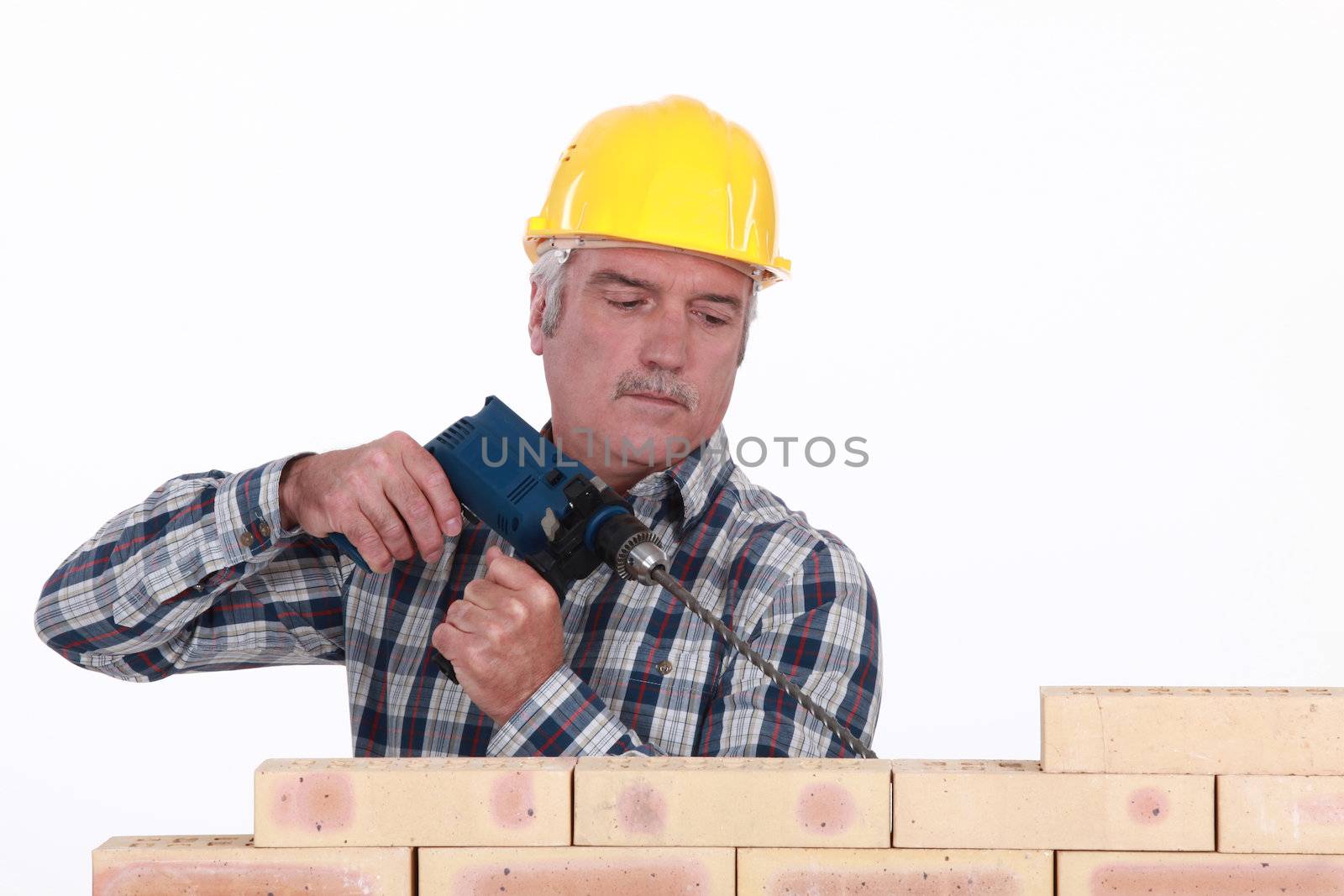 Tradesman using a screwdriver by phovoir