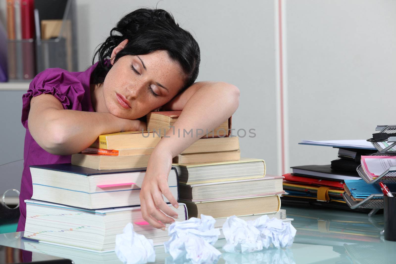 Woman sleeping on her books