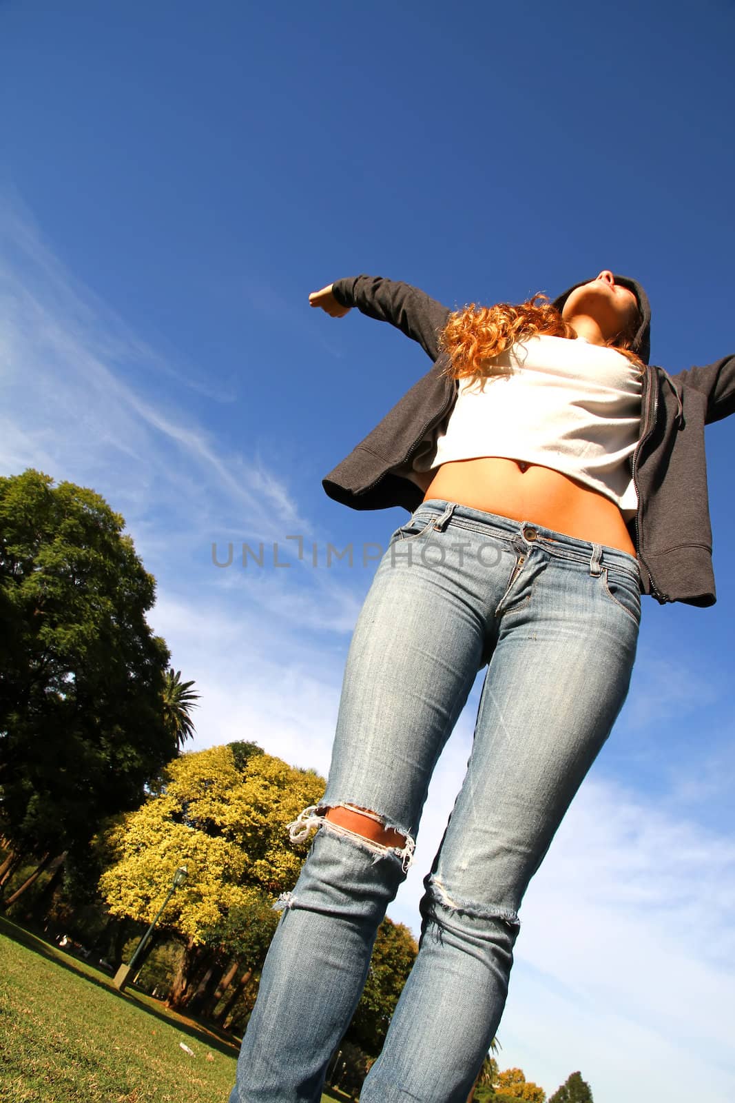 A young woman enjoying the sunlight in the Park.			