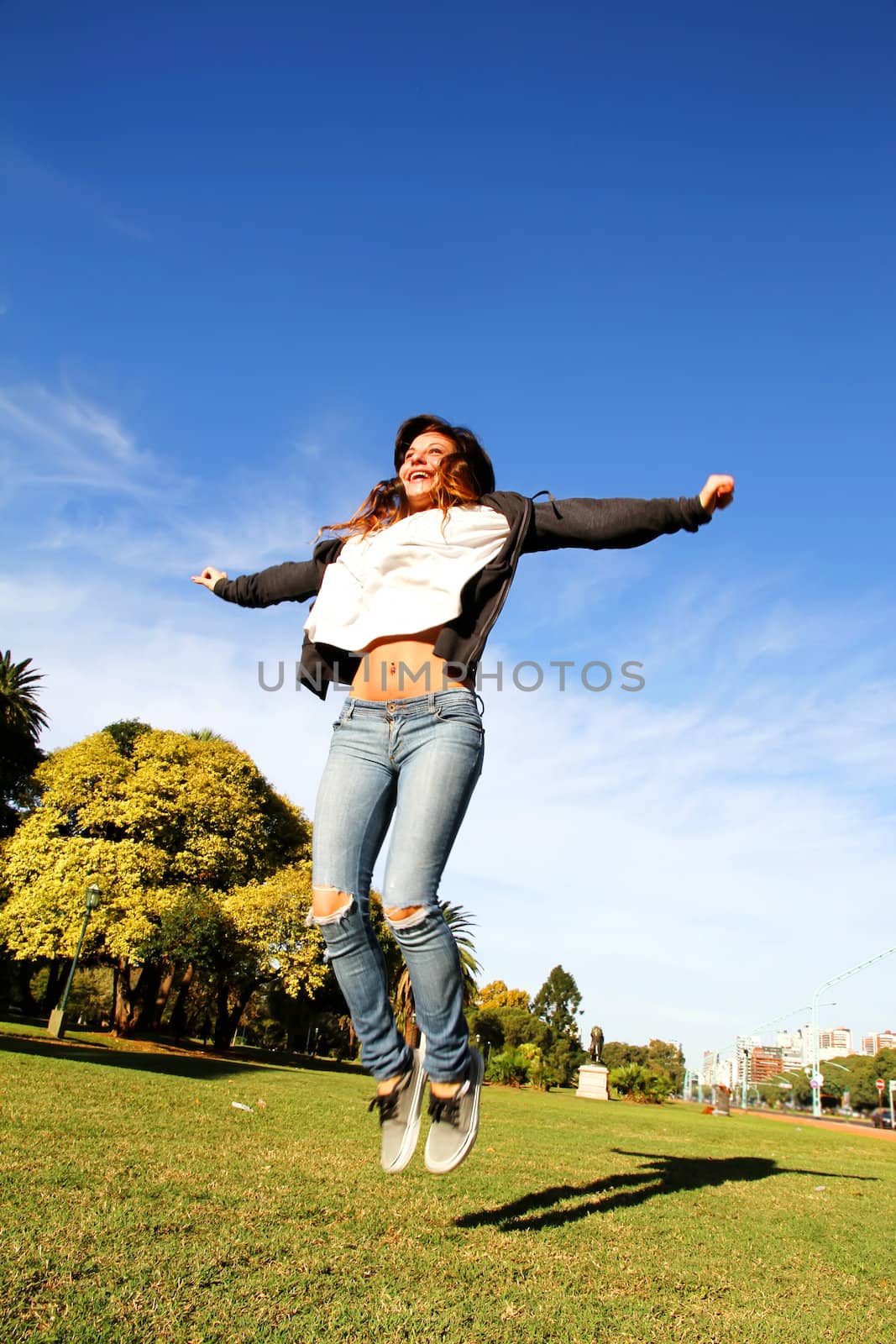 A young woman jumping in the Park.