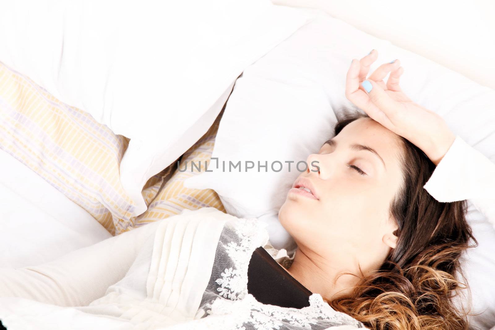 A woman lying alone on the bed.
