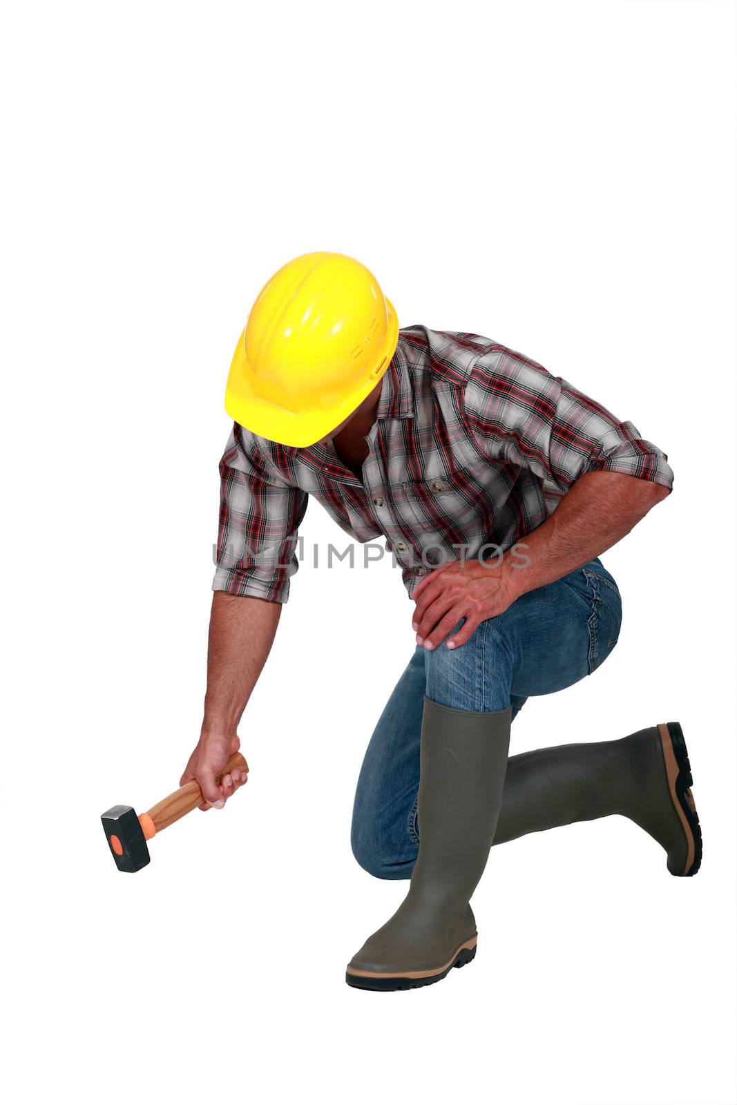 A manual worker with a hammer.