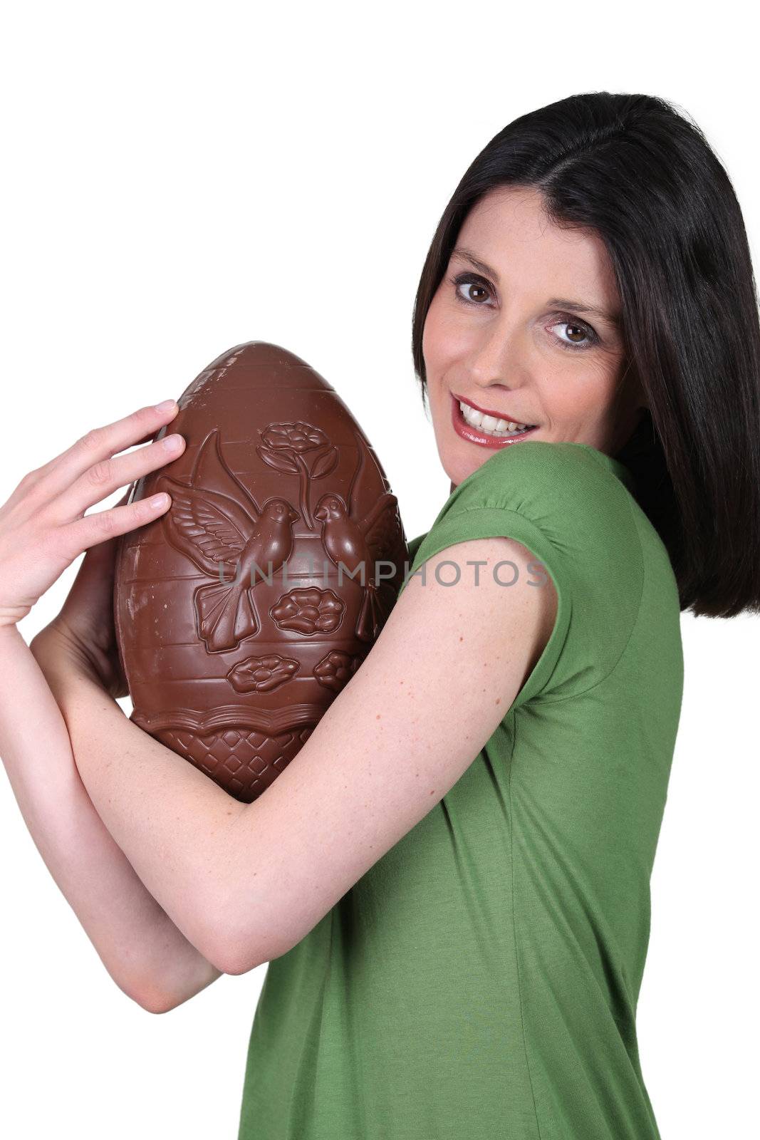 Woman holding a large chocolate Easter egg by phovoir
