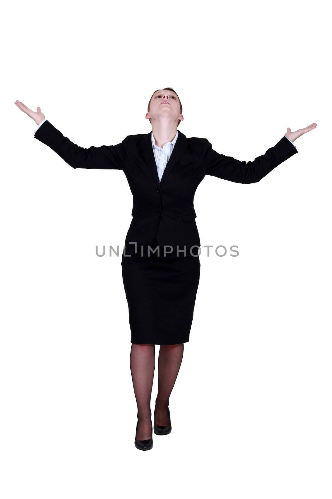 Businesswoman with raised arms by phovoir