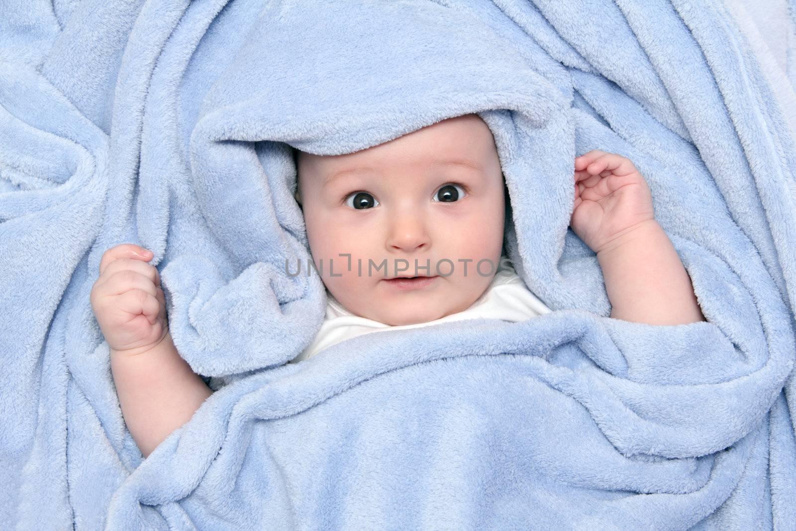 beautiful baby after bath under a blanket by NikolayK
