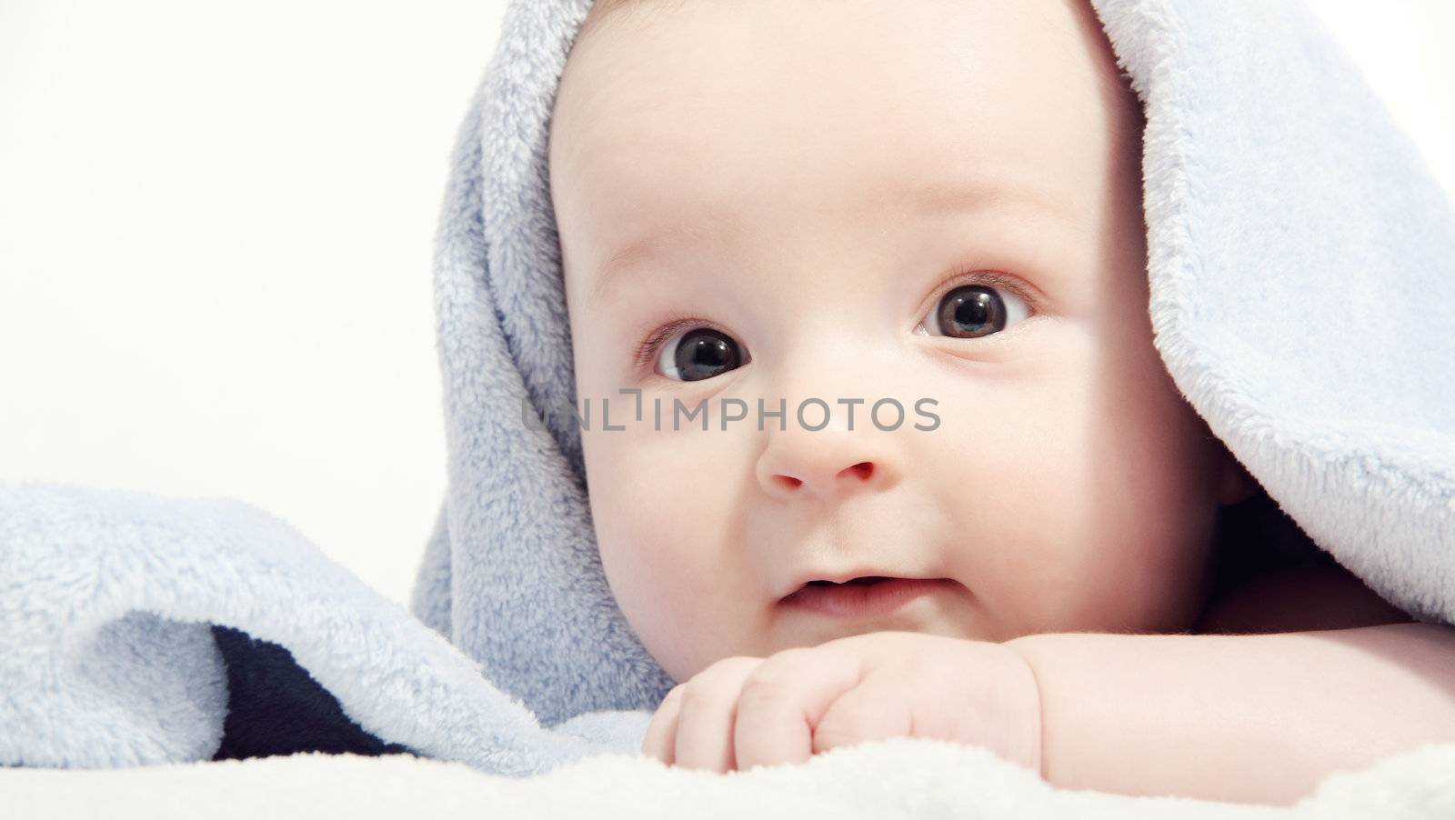 baby after bath under a blanket by NikolayK