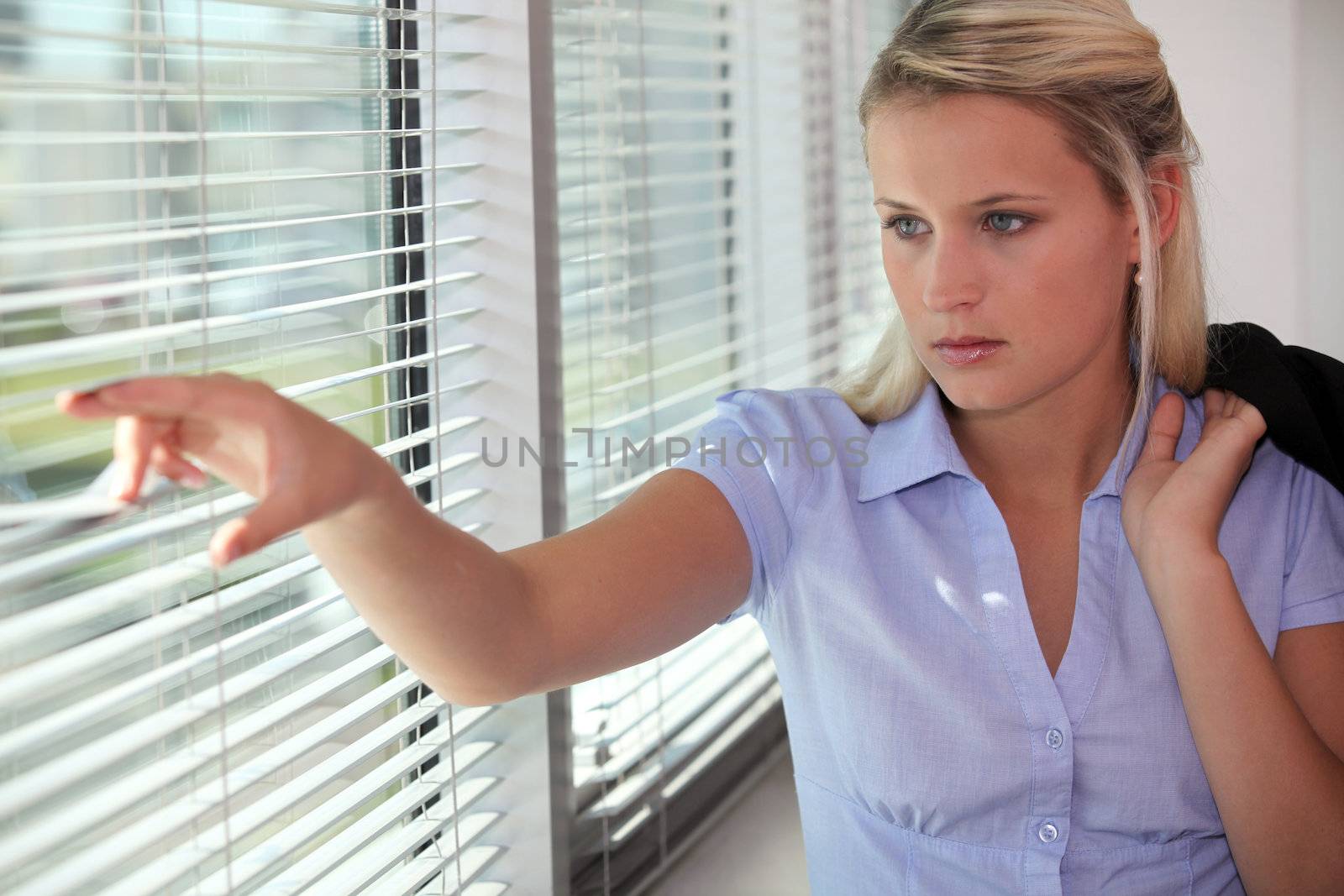 cute blonde behind blinds