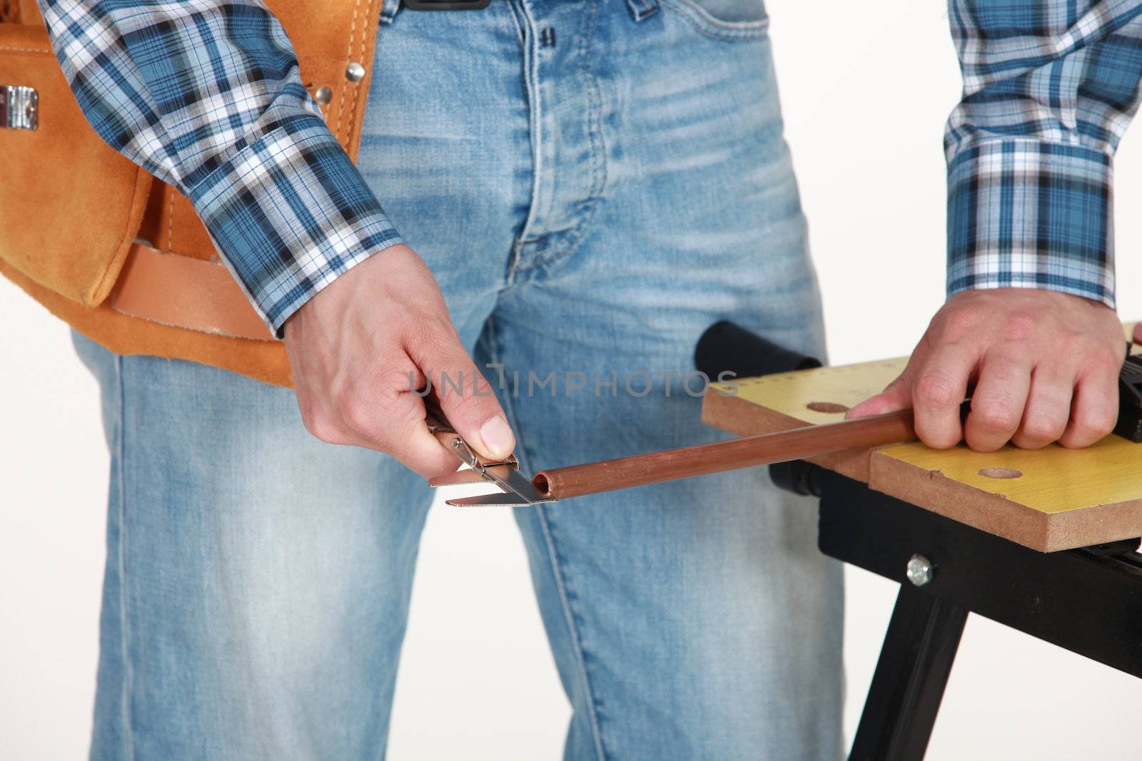 closeup of carpenter working on workbench by phovoir