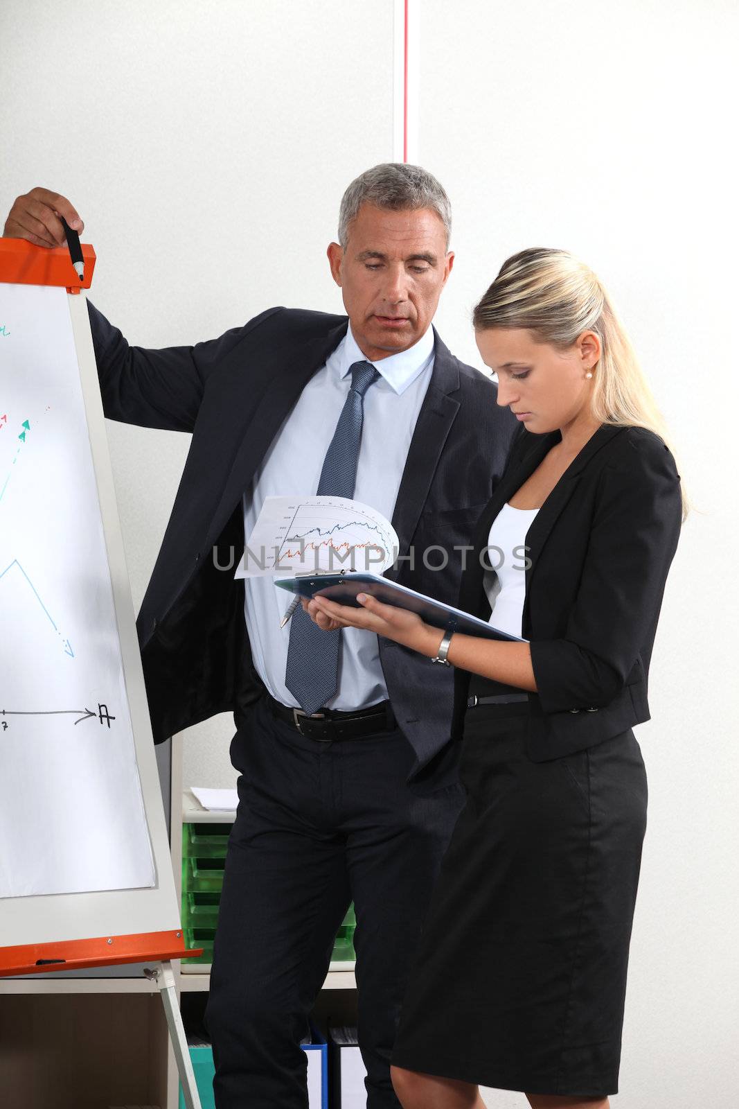 A team of business professionals reviewing their data before a presentation