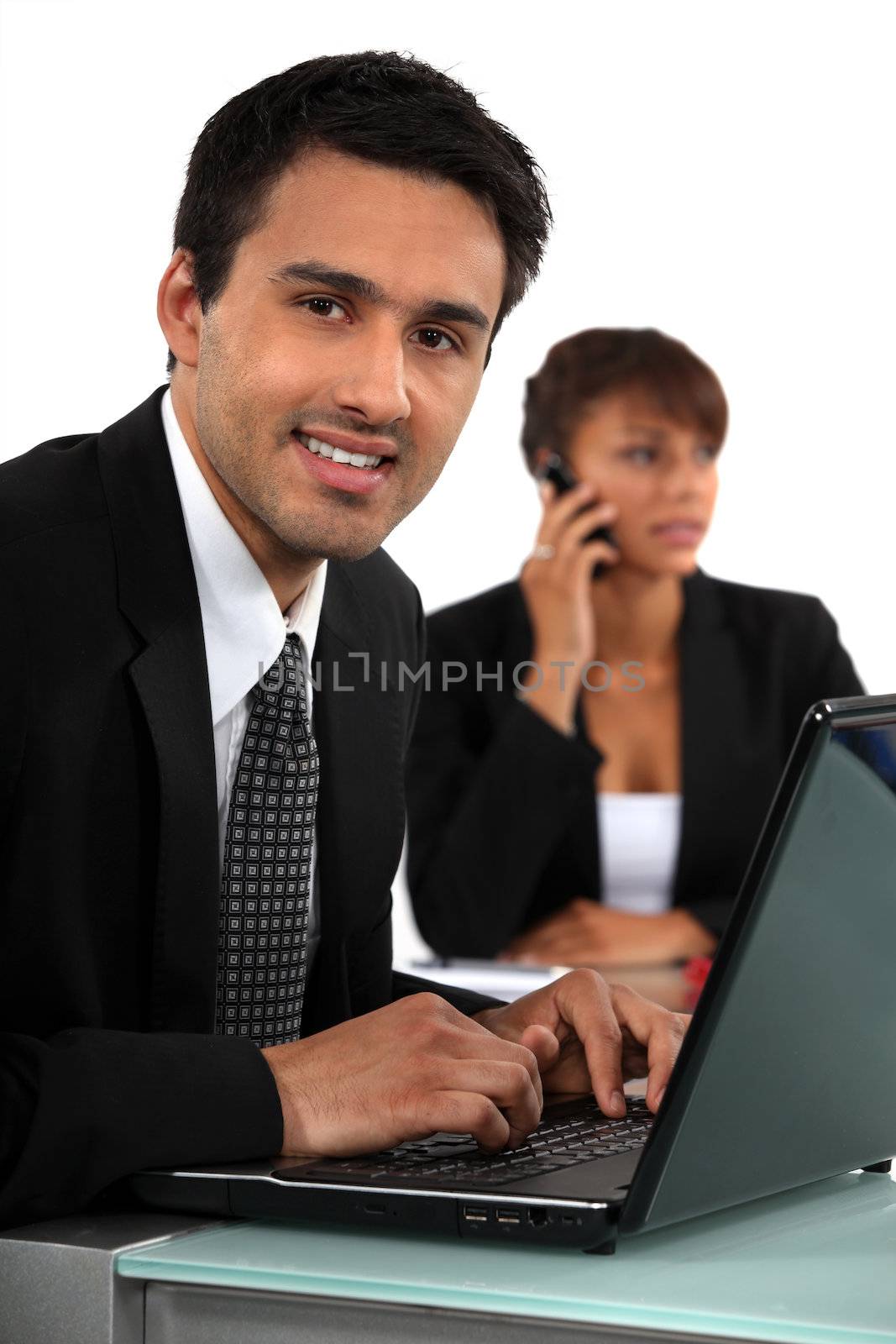 Smiling businessman with a laptop