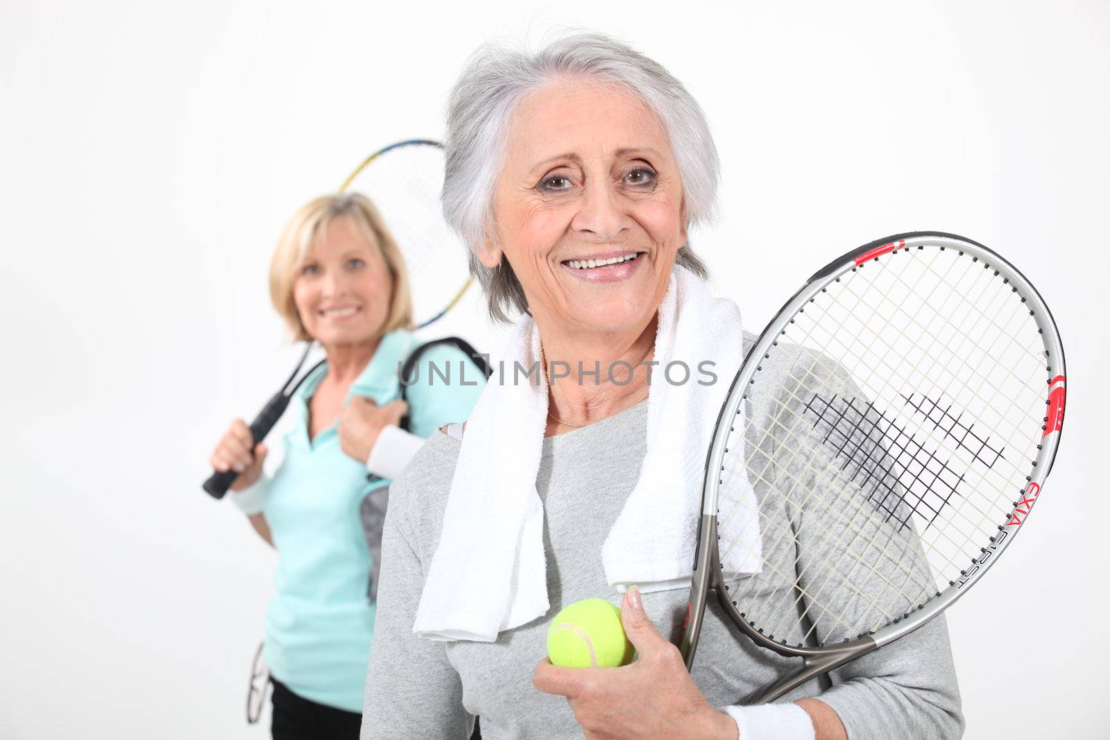 two senior women doing tennis