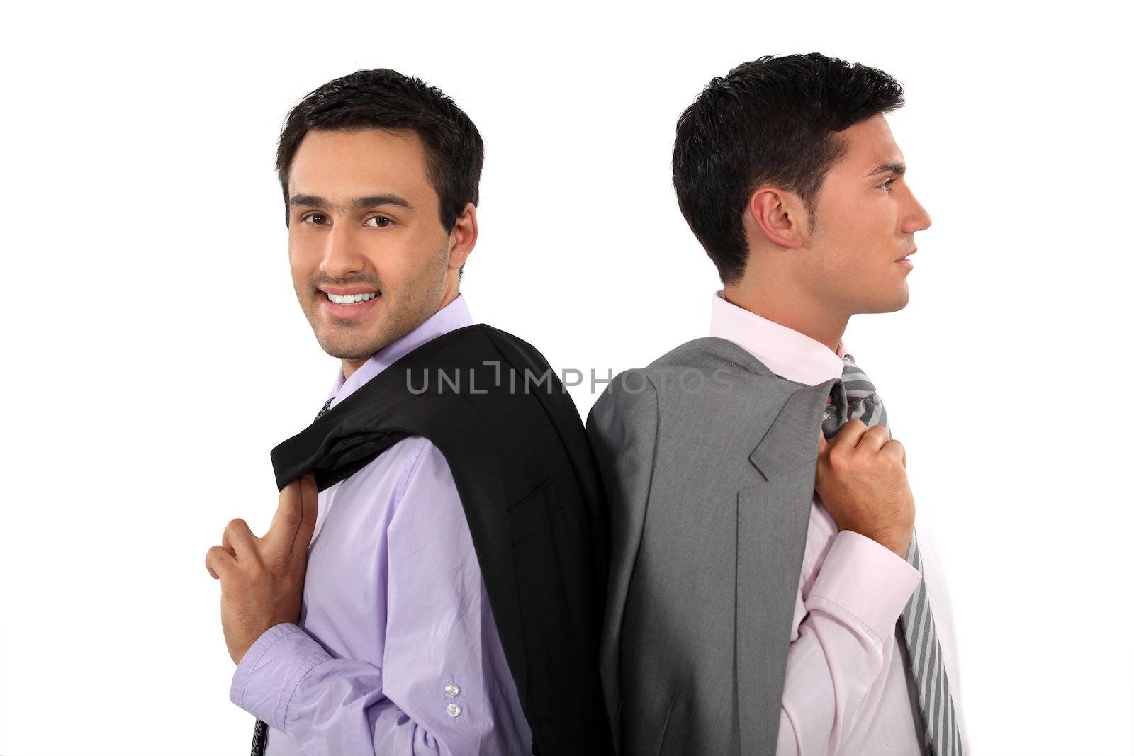 Two businessmen with jackets over shoulders by phovoir