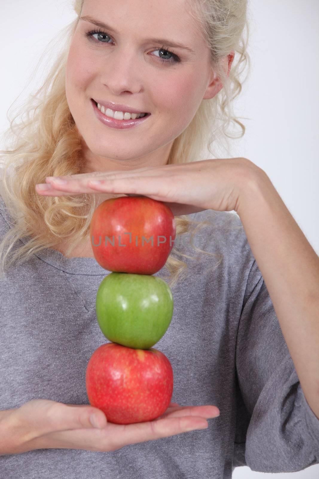 Woman holding a stack of apples by phovoir