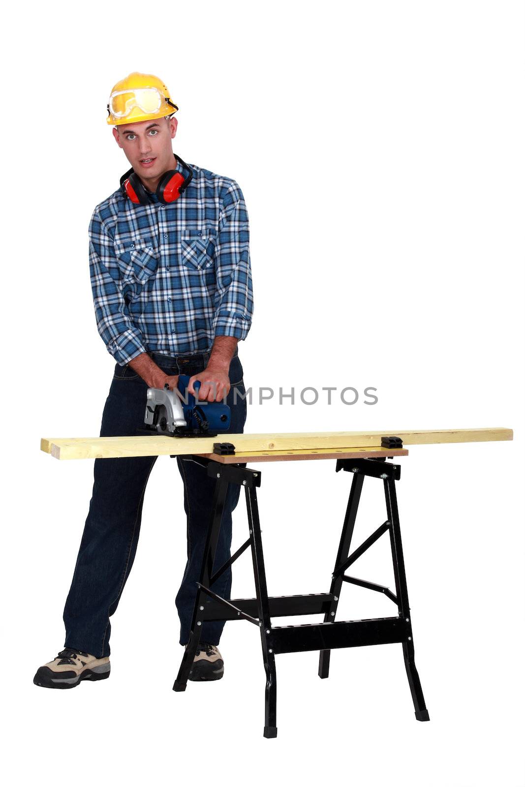 A carpenter with a circular saw. by phovoir