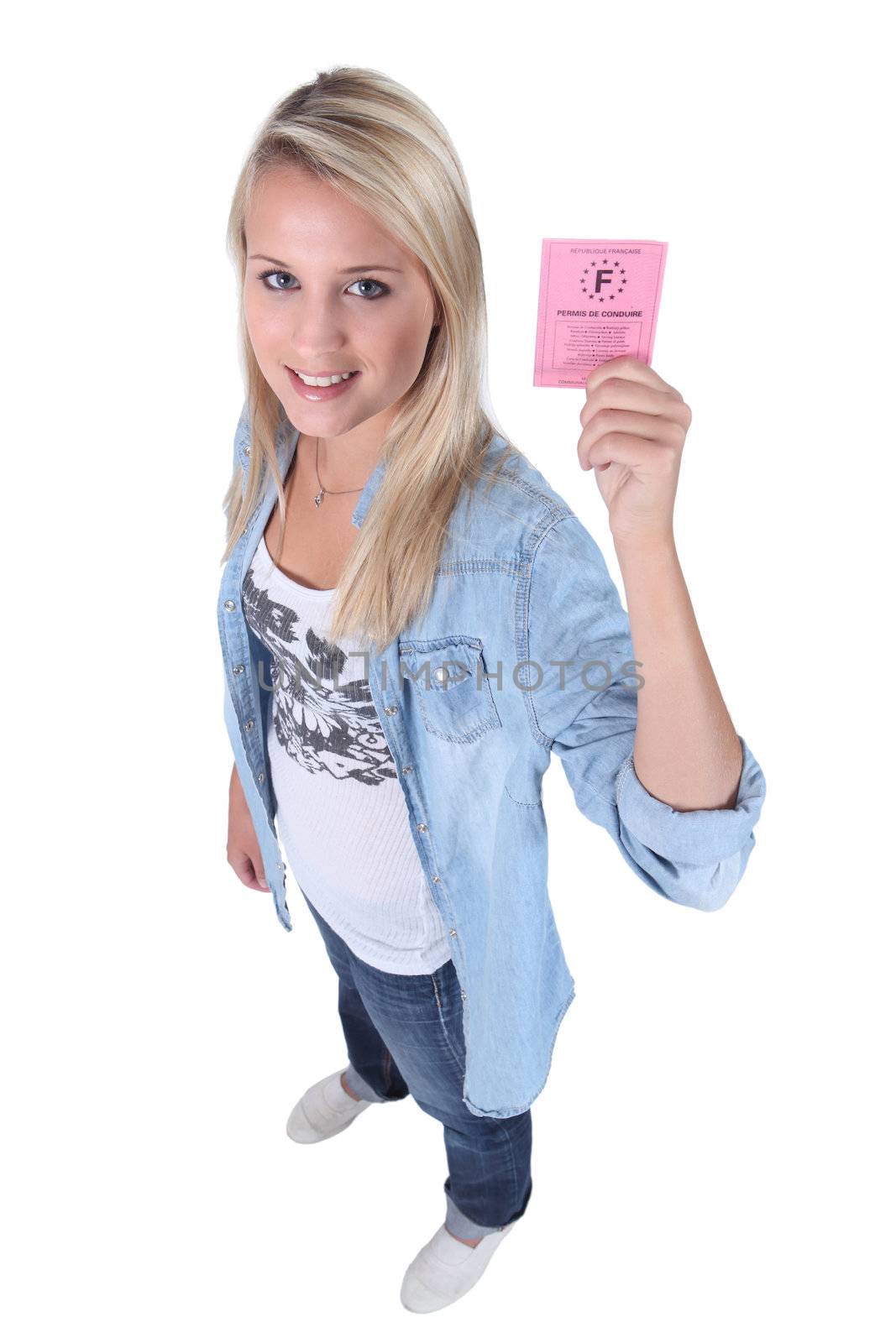 Blond teenage girl holding driving license
