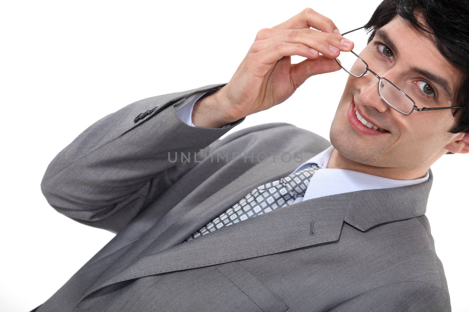 Businessman removing glasses by phovoir
