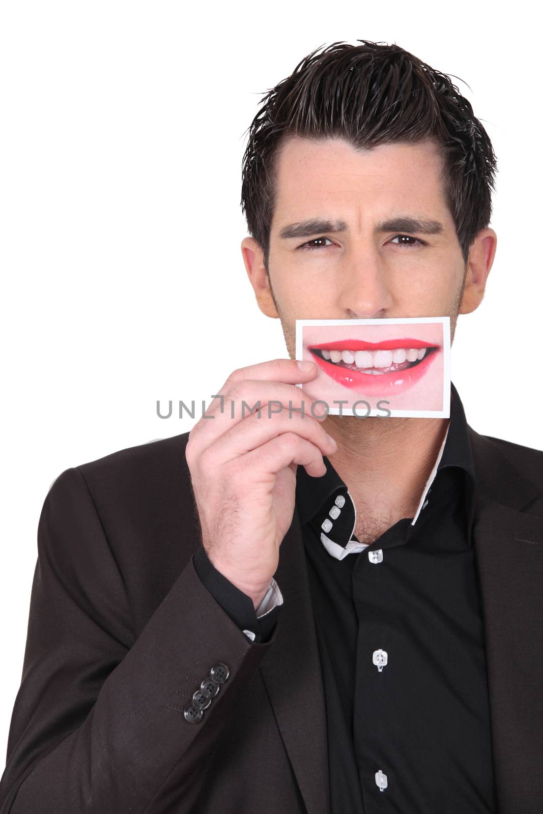 dark-haired man holding picture of female mouth smiling Narbonne_Neil_160410 by phovoir