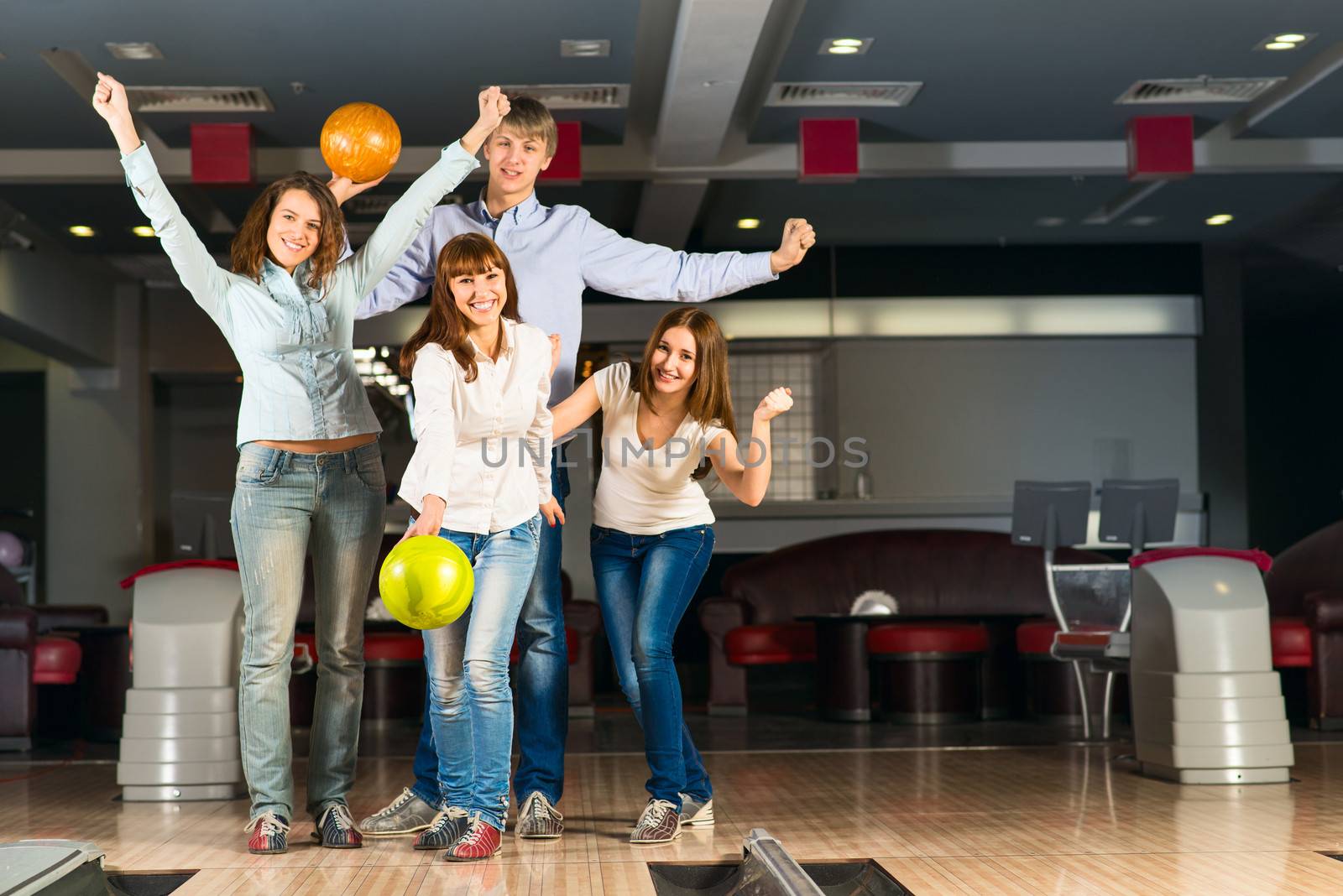 Group of young friends playing bowling by adam121