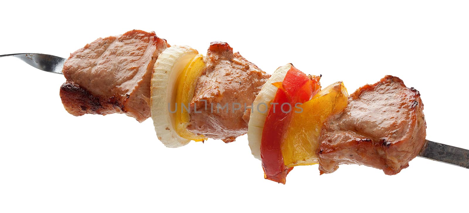 Hot roasted meat with onion, tomato and papper on the metal skewer