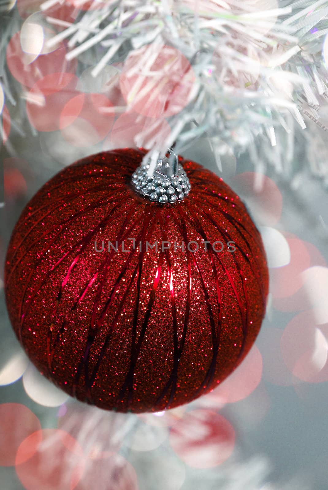 red glitter christmas ornament with red glowing lights