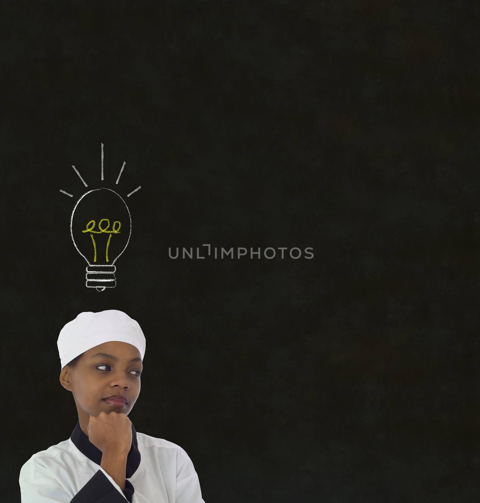 Lightbulb idea African woman chef on chalk blackboard background by alistaircotton