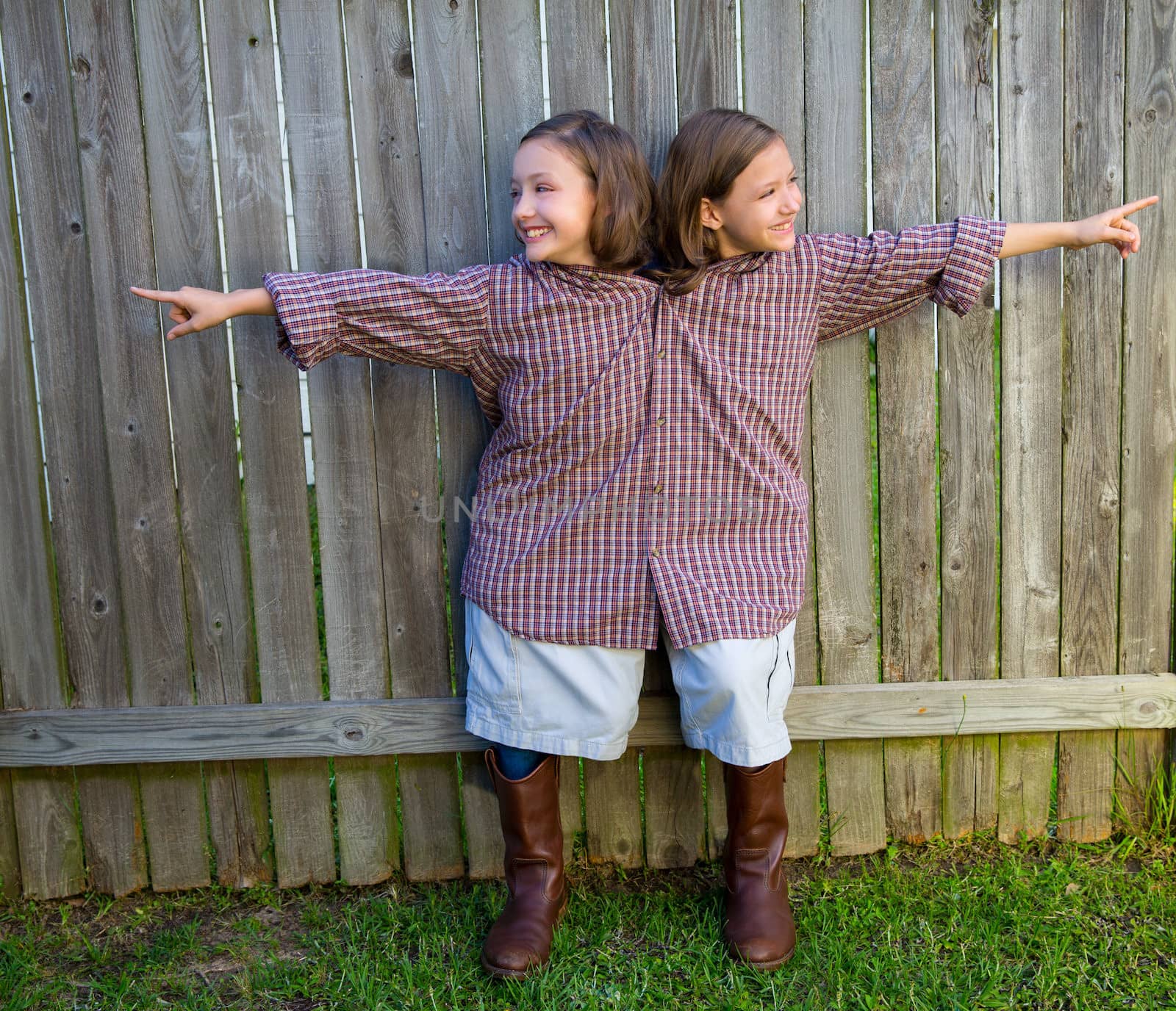 twin girls fancy dressed up pretending be siamese with his father shirt pointing finger