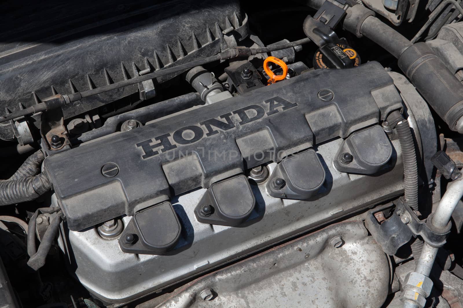 Lubaczow, Poland – July 22, 2013; Close-up of a 1.4l Honda petrol engine under the hood of a 2004 Honda Civic.