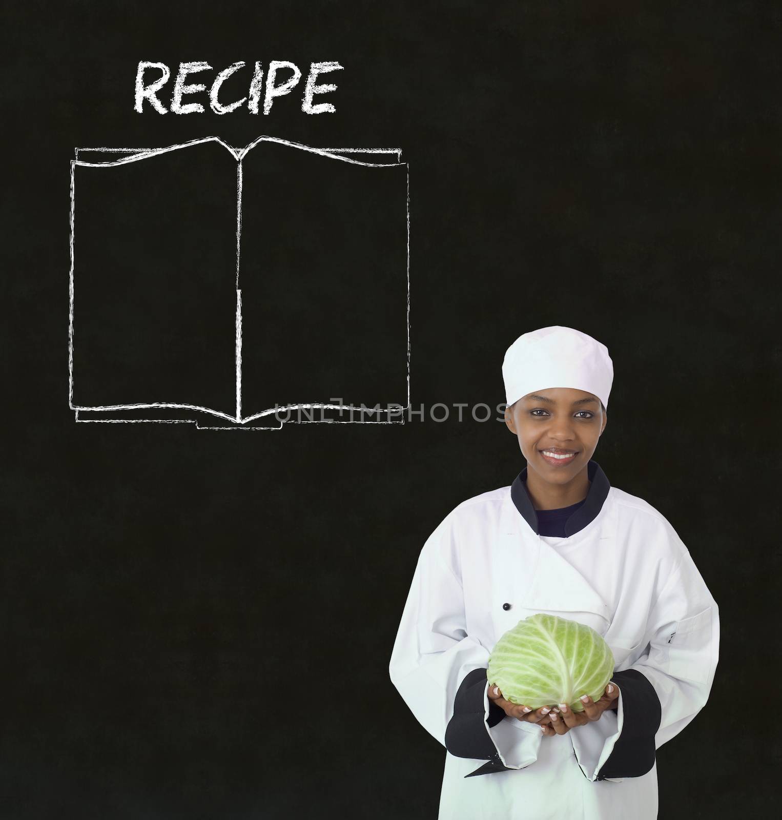Chef with recipe book on chalk blackboard menu background by alistaircotton