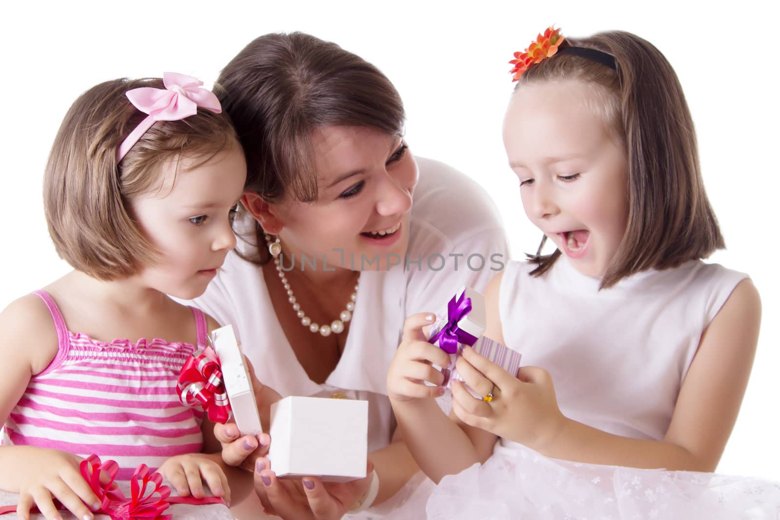 Mother with two daughters offering surprise box isolated over white