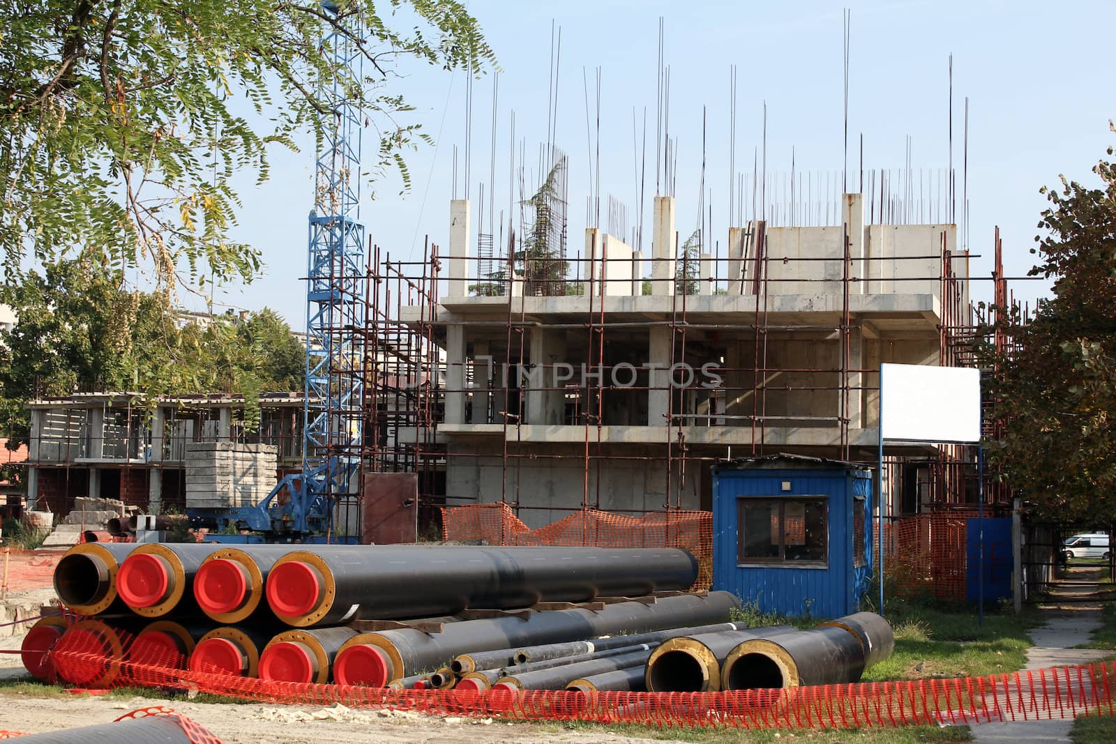 building construction site with tubes and crane