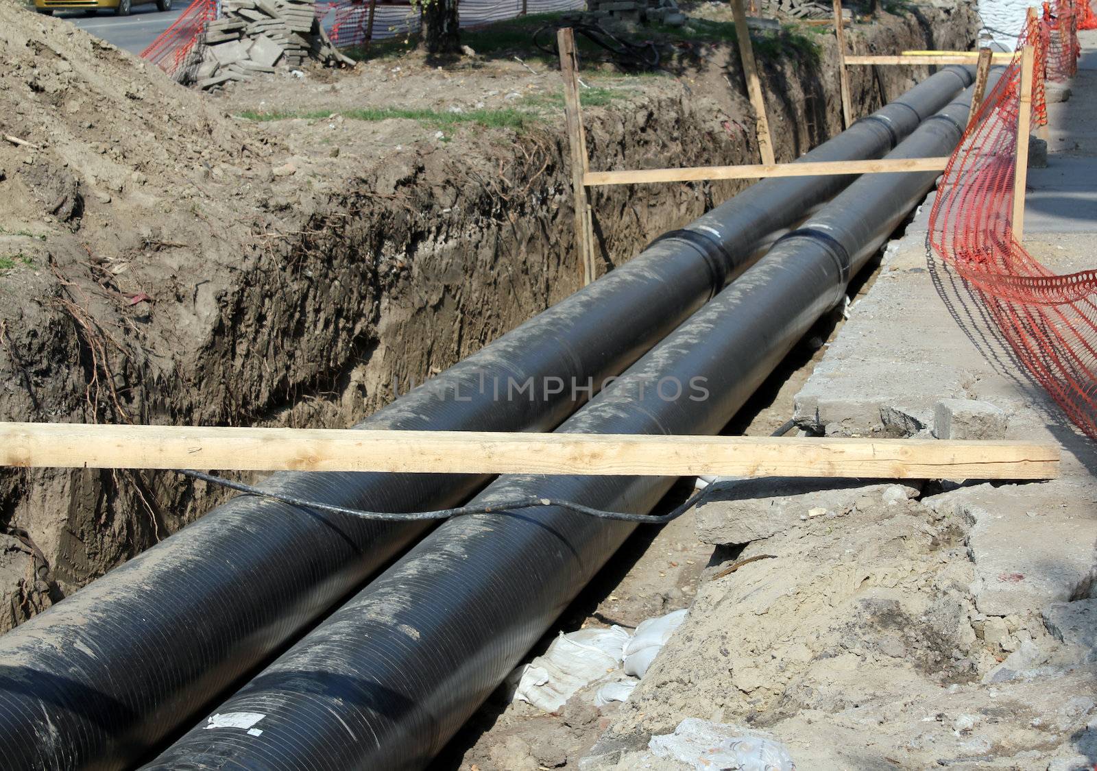 construction site with community heating system pipes by goce
