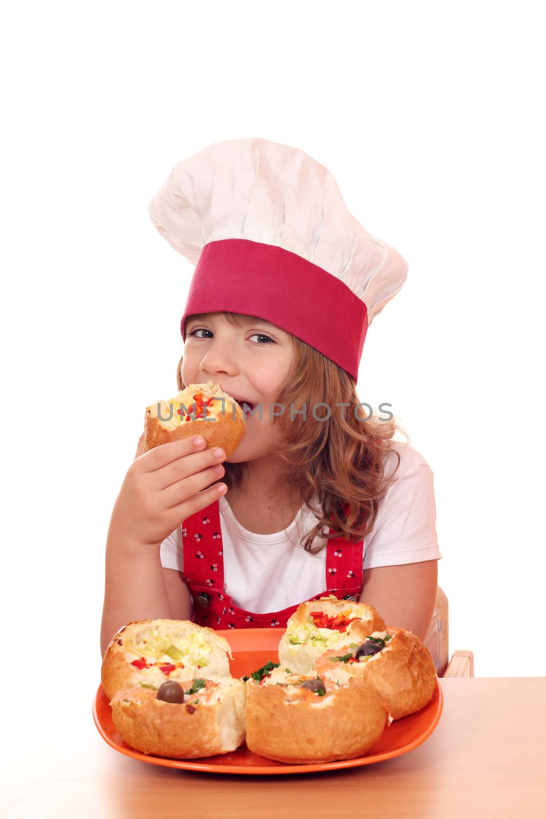 little girl cook eat bread filled with cheese and vegetables by goce