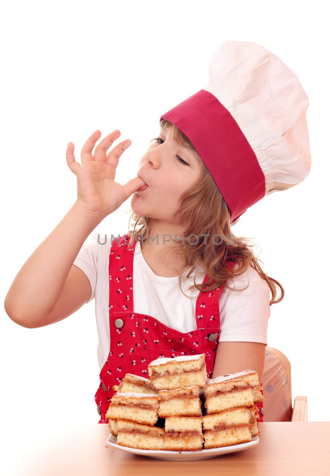 little girl cook licks the sugar from finger