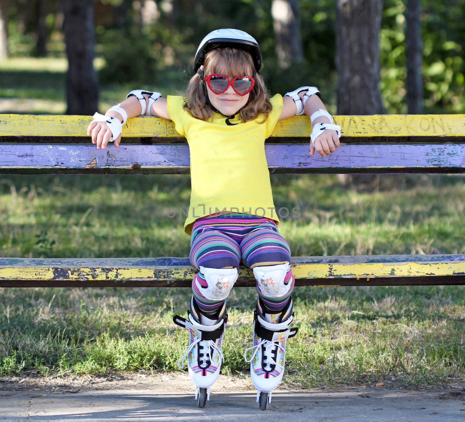 little girl with sunglasses and roller skates