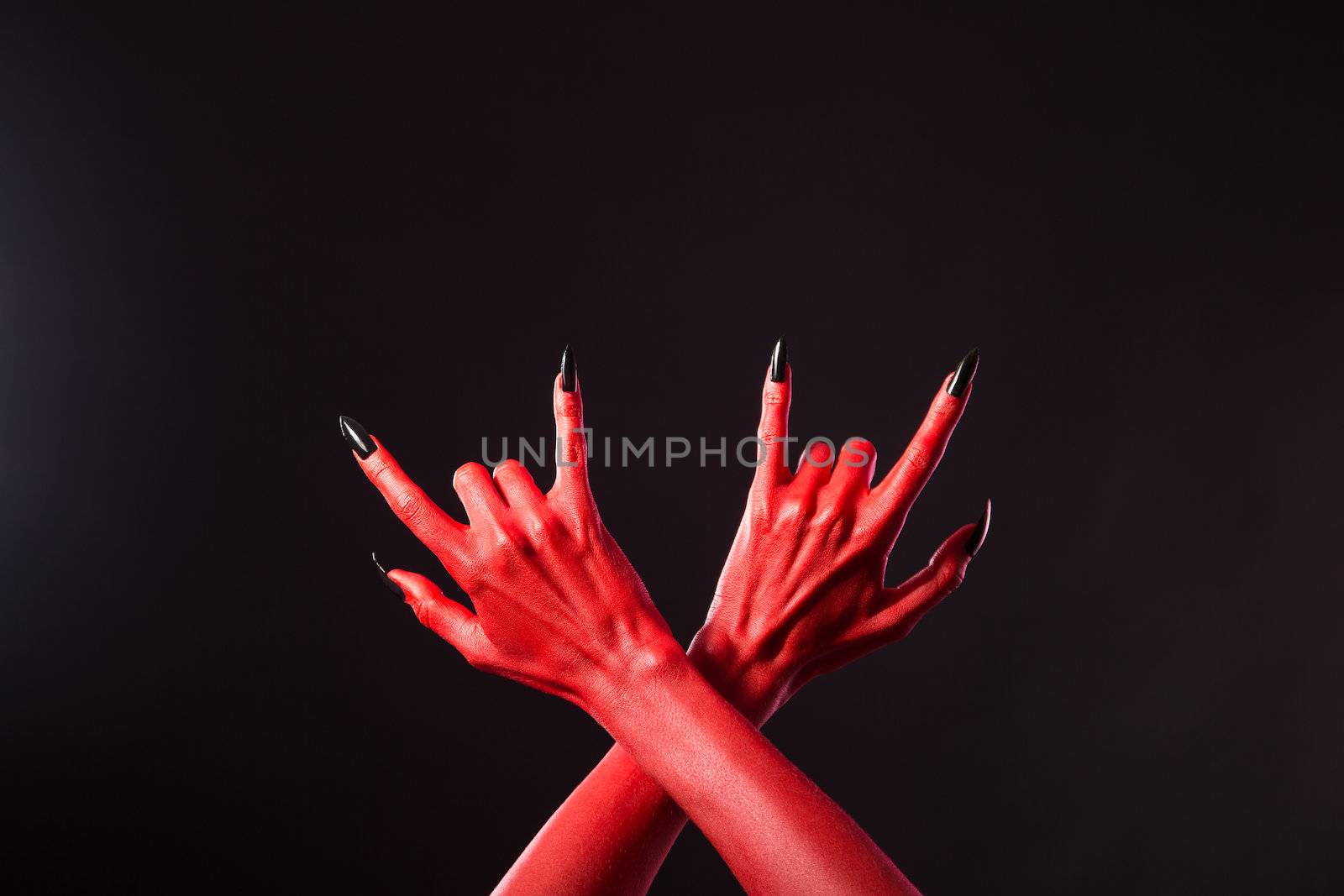 Red devil hands showing heavy metal gesture, Halloween theme 