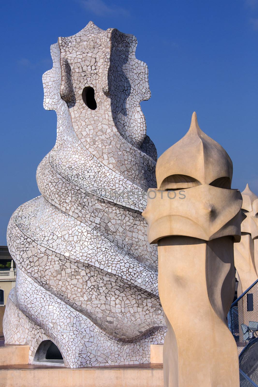 Ornate chimney designs on the roof of Gaudi's Casa Milia in the Eixample district of Barcelona in the Catalonia region of Spain.