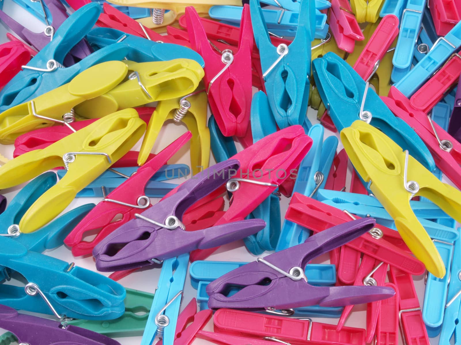 Close up of multicoloured plastic clothes pegs.