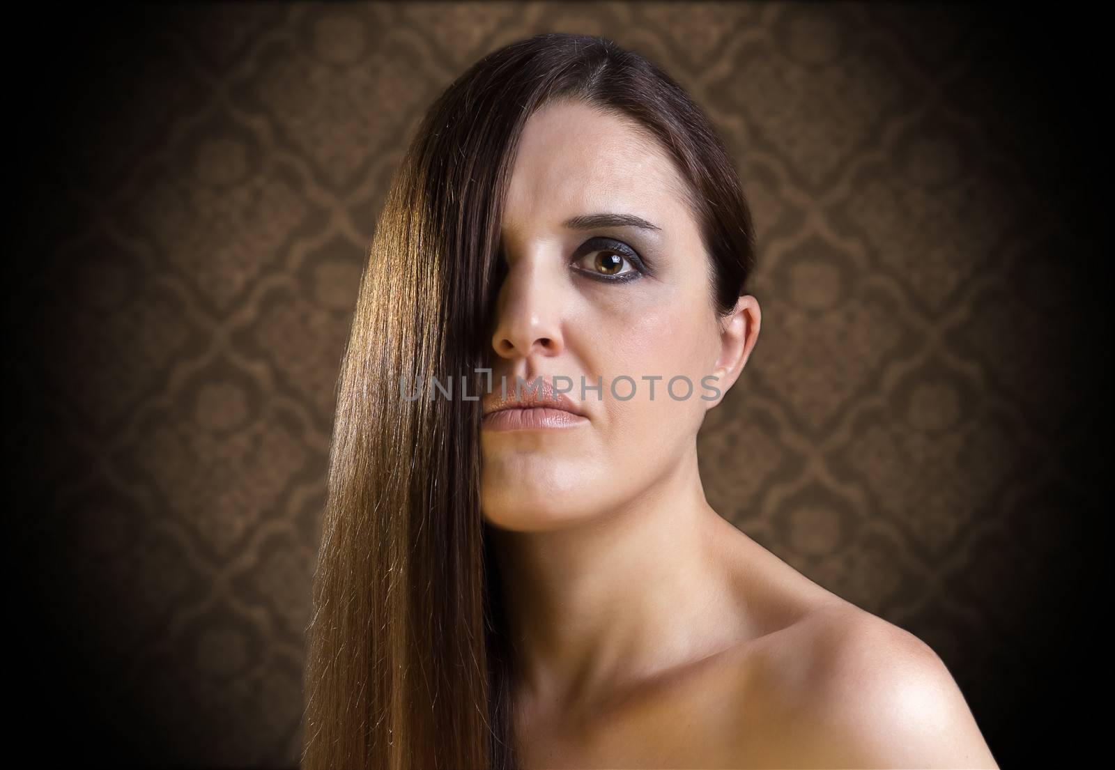 Beautiful girl with long  and healthy brown hair isolated on vintage background