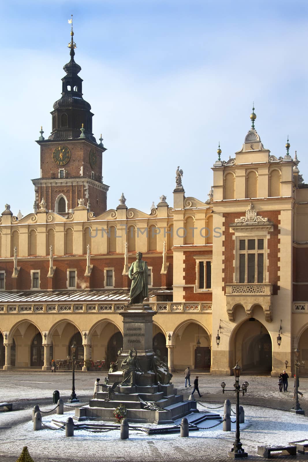 The Cloth Hall (Sukiennice) and Town Hall Tower in the main market square (Rynek Glowny) in Cracow in Poland. The statue is of Adam Mickiewicz.  The Cloth Hall dates from 1895.