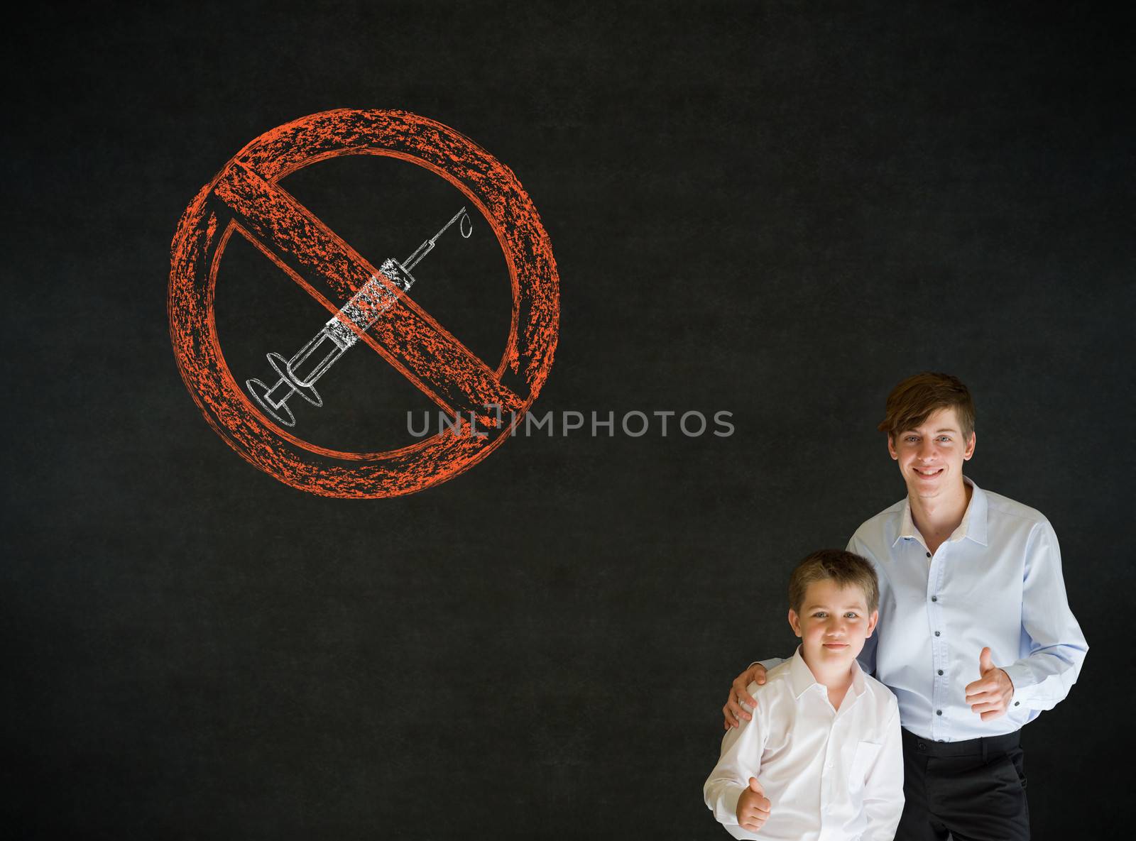 Thumbs up boy dressed up as business man with teacher man and no drugs needle sign on blackboard background