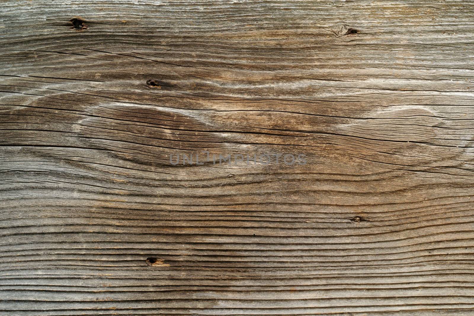 Photo of a rough wood board from a rustic old barn.

