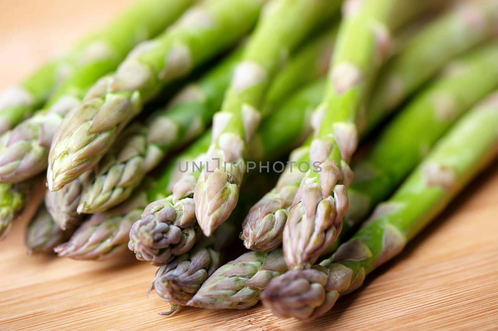 Close-up of freshly harvested asparagus on cutting board.