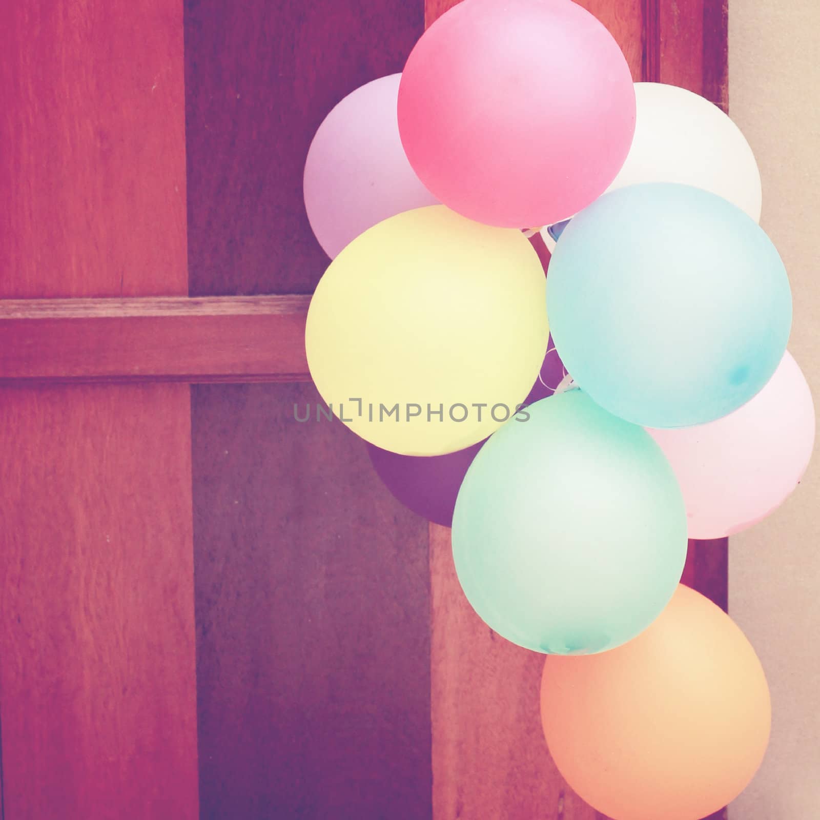 Multicolored balloons hanging on door by nuchylee
