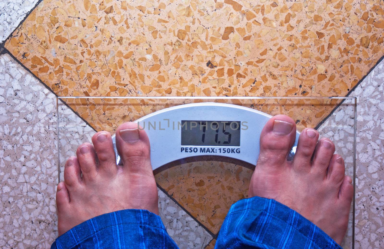 A scale with two feet of the person standing on it